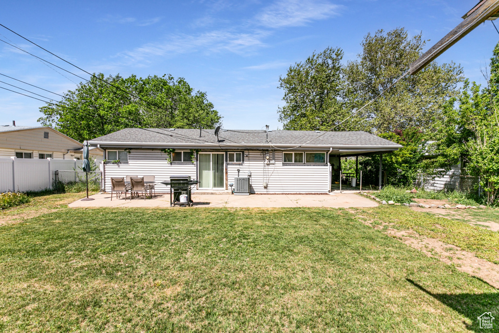 Rear view of property with a patio, central AC unit, and roof with shingles