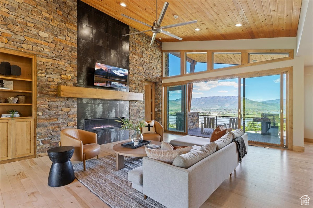 Living area with wood ceiling, a fireplace, wood-type flooring, ceiling fan, and recessed lighting