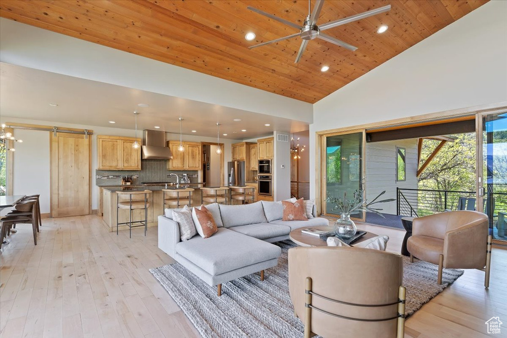 Living area featuring wood ceiling, high vaulted ceiling, recessed lighting, a ceiling fan, and light wood finished floors