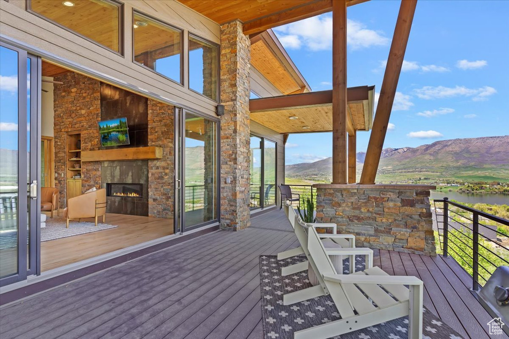 Wooden deck with an outdoor stone fireplace