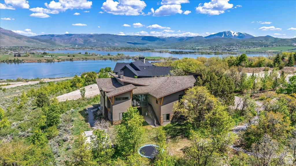 View of subject property featuring a water and mountain view