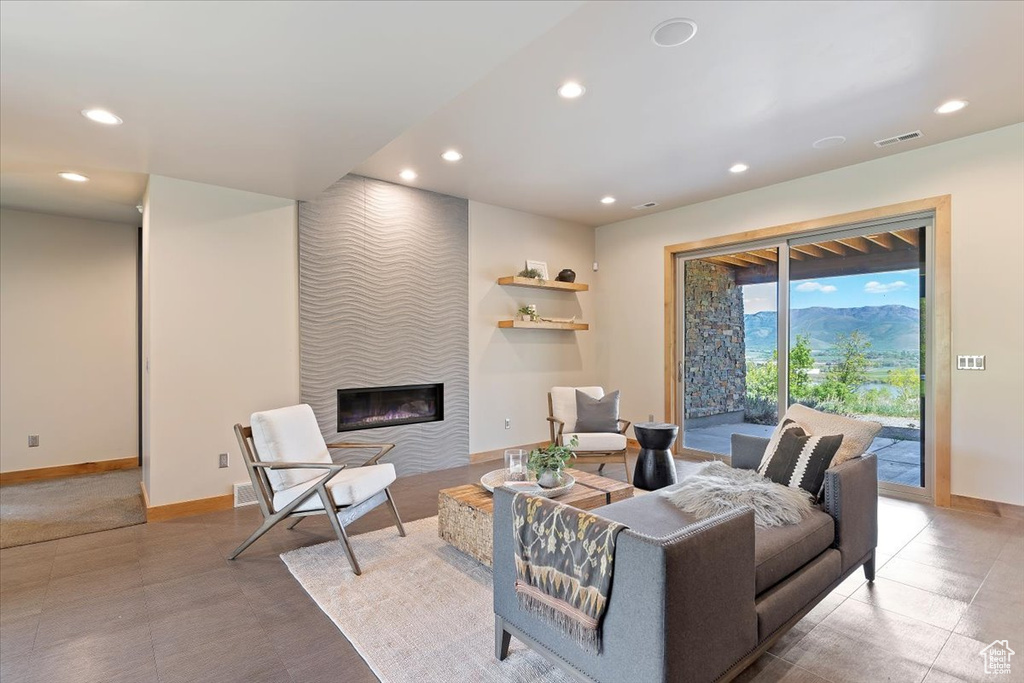 Living room with recessed lighting, baseboards, and a tile fireplace