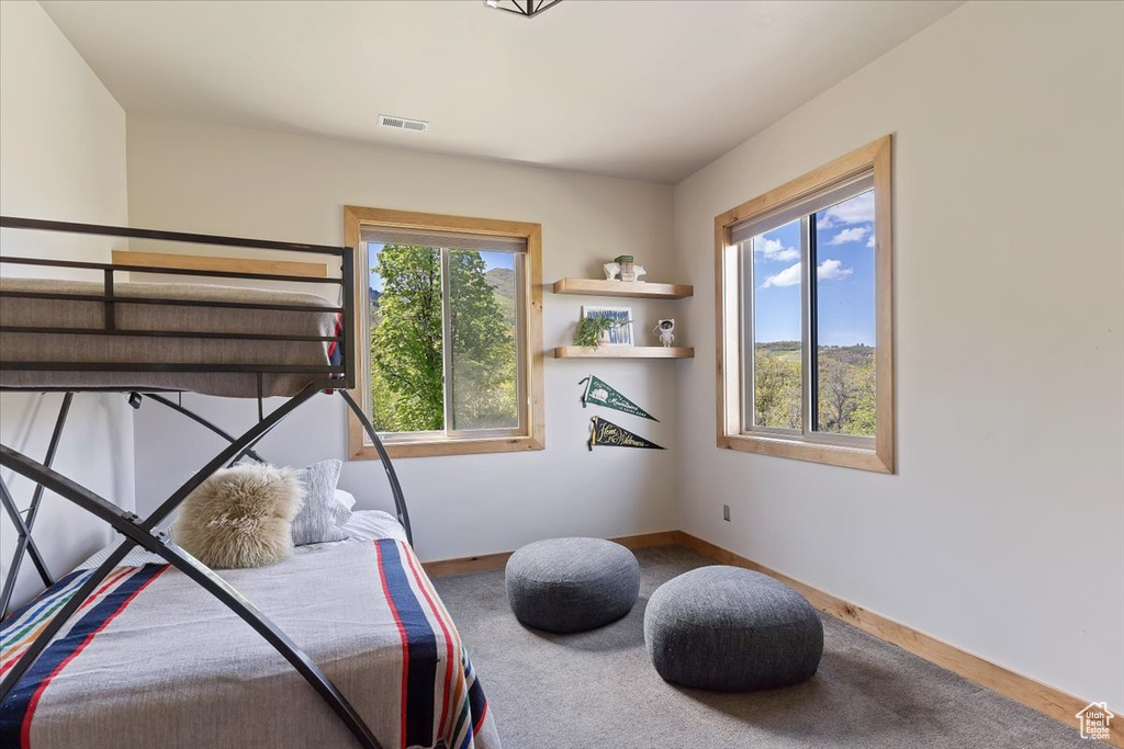 Carpeted bedroom featuring baseboards