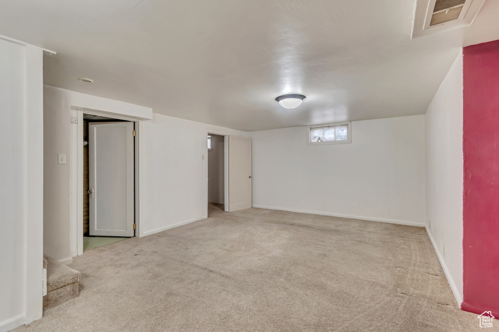 Below grade area with carpet flooring and baseboards