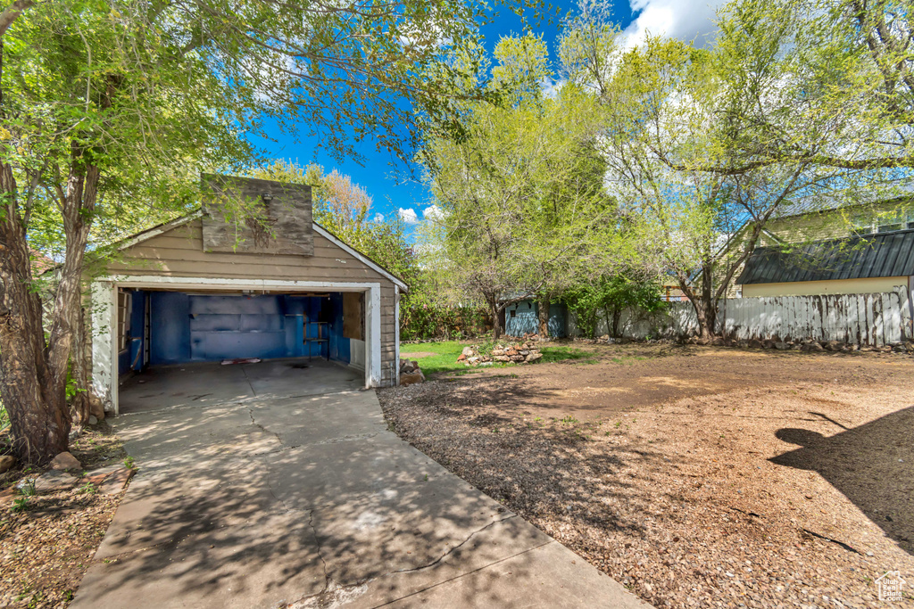Detached garage featuring fence