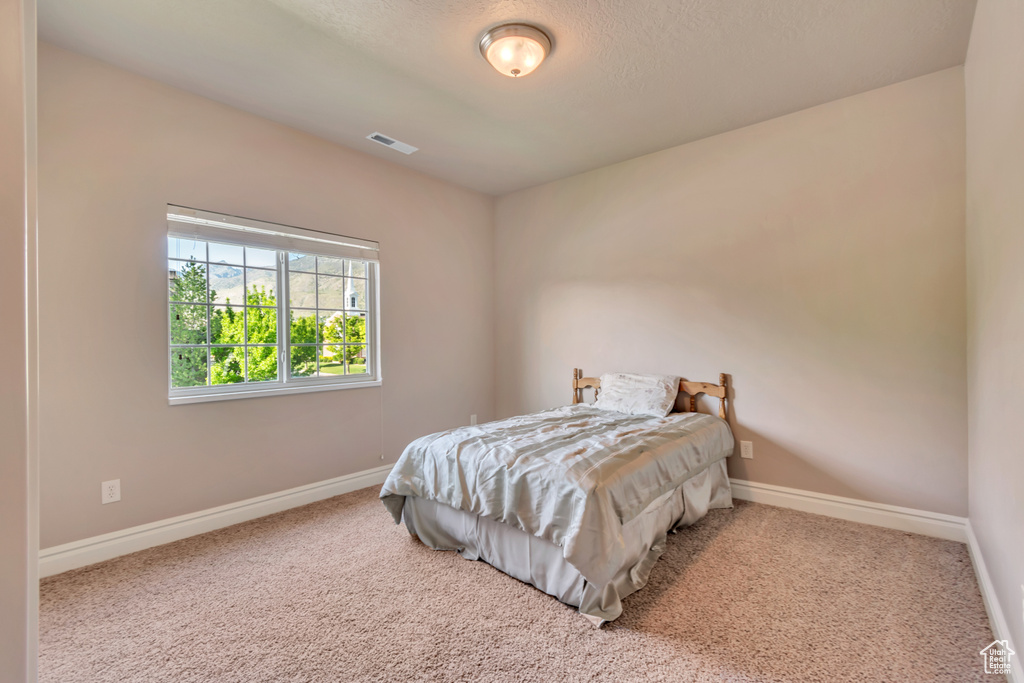 Carpeted bedroom featuring baseboards