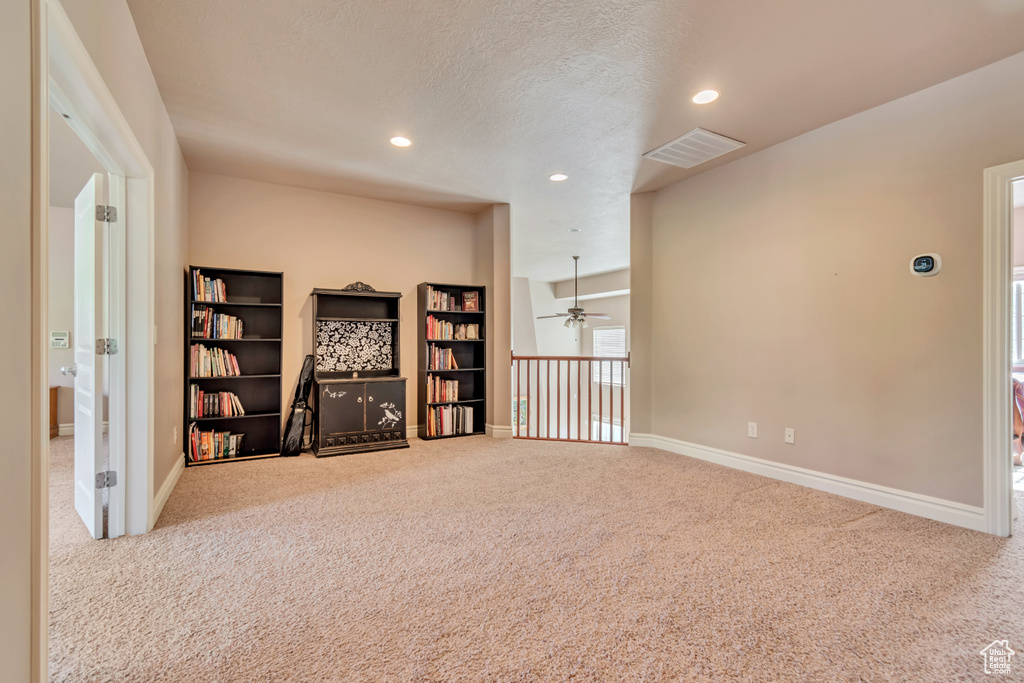 Carpeted empty room featuring recessed lighting, ceiling fan, baseboards, and a textured ceiling