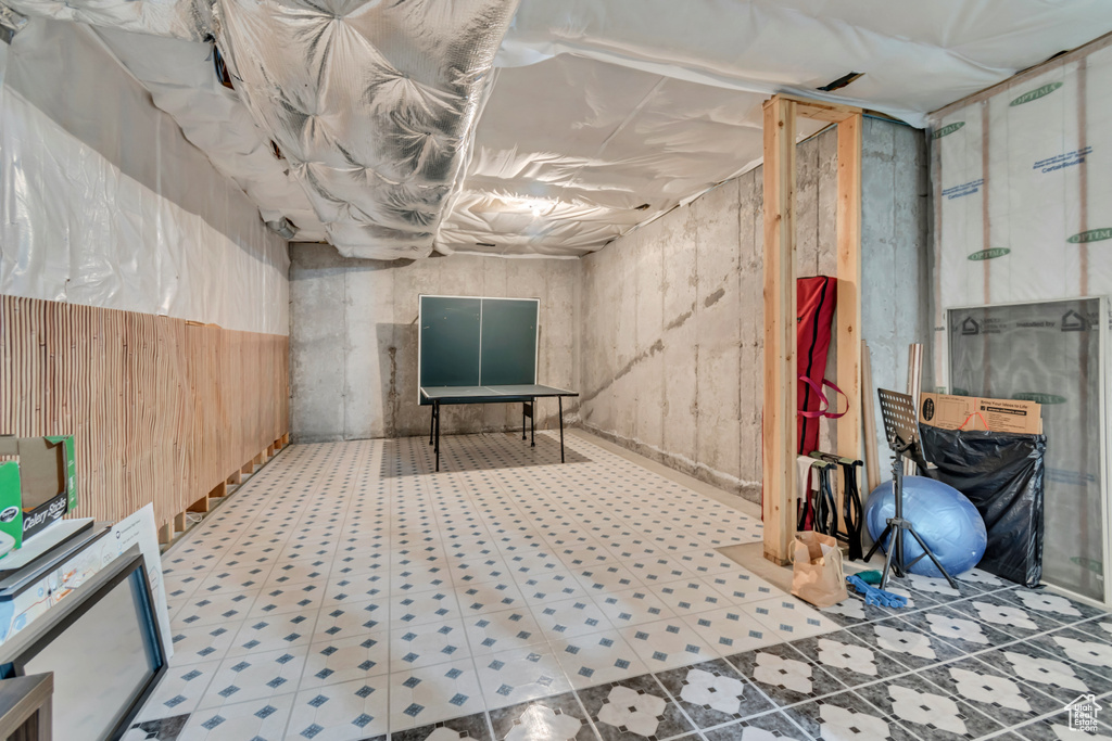 Unfinished basement with tile patterned floors
