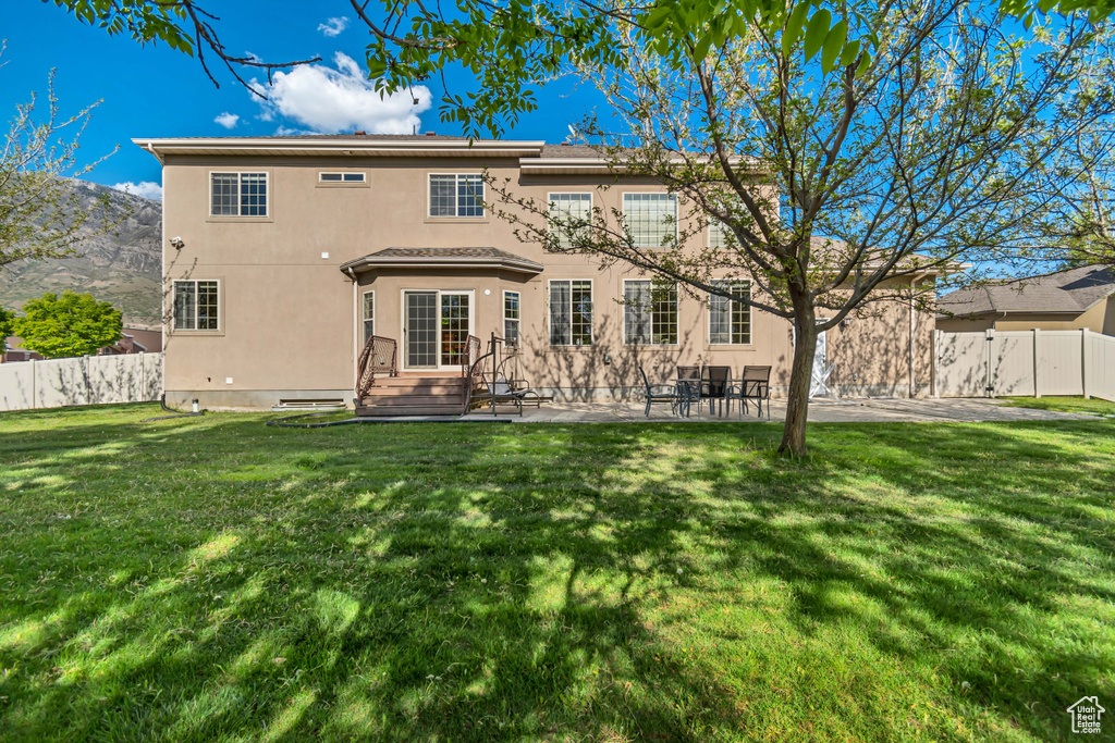 Back of house featuring stucco siding