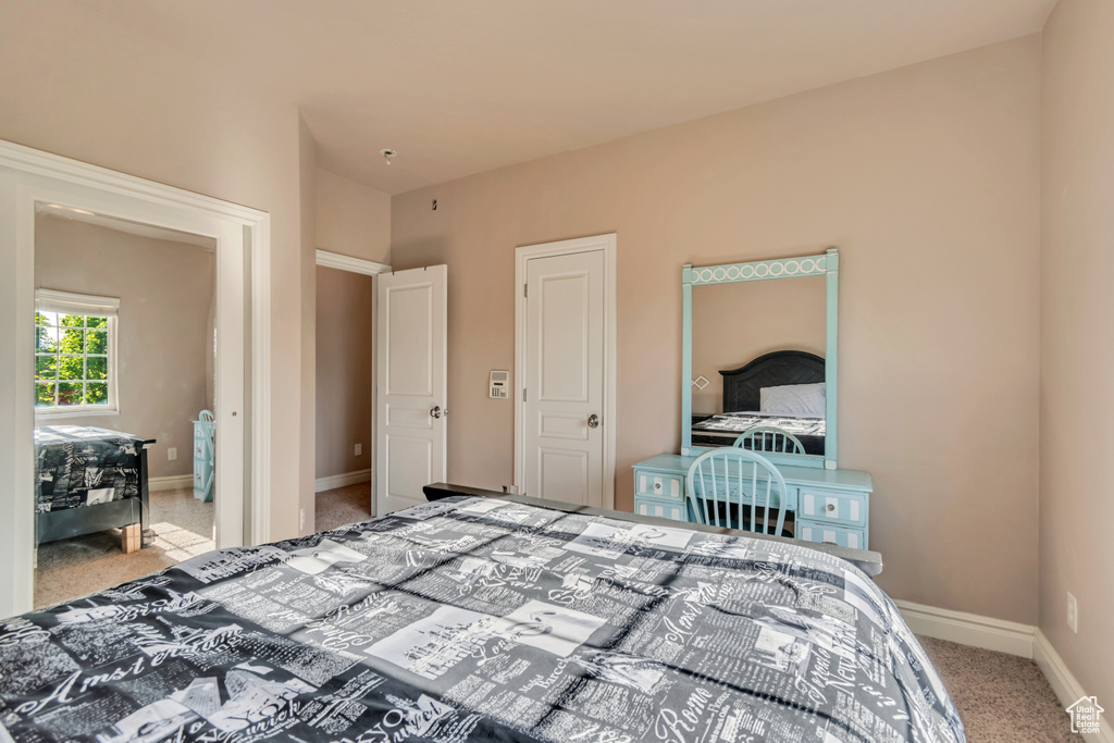 Bedroom with carpet floors and baseboards