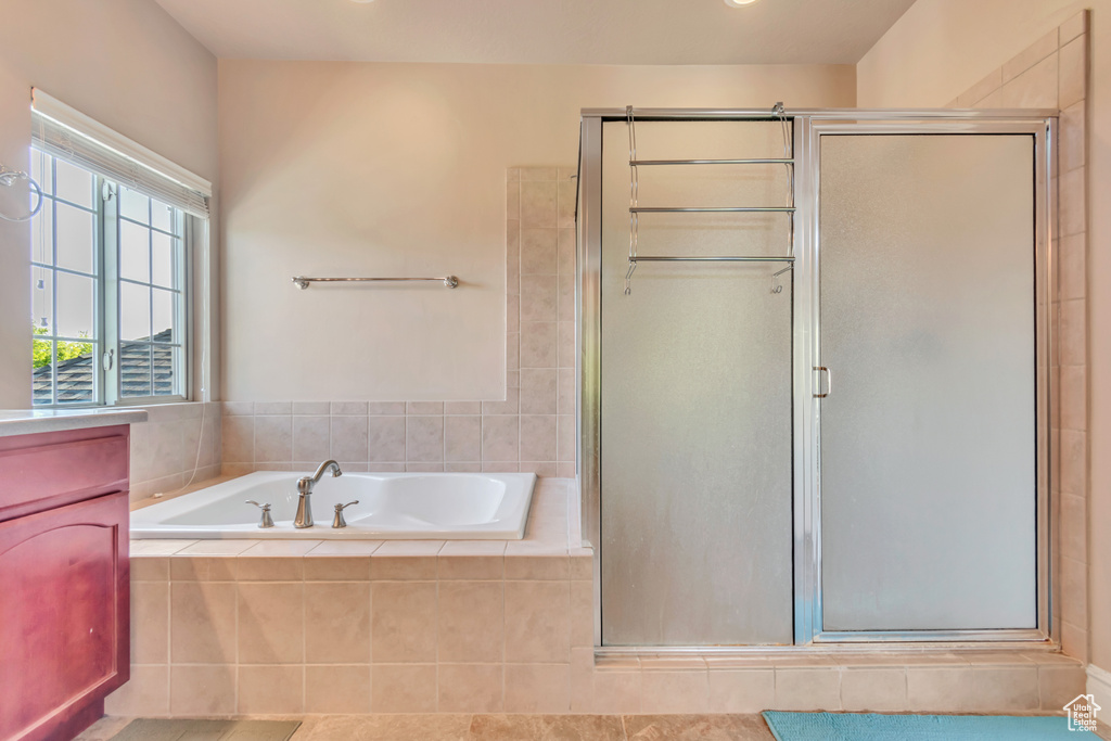 Full bath with a stall shower and a garden tub