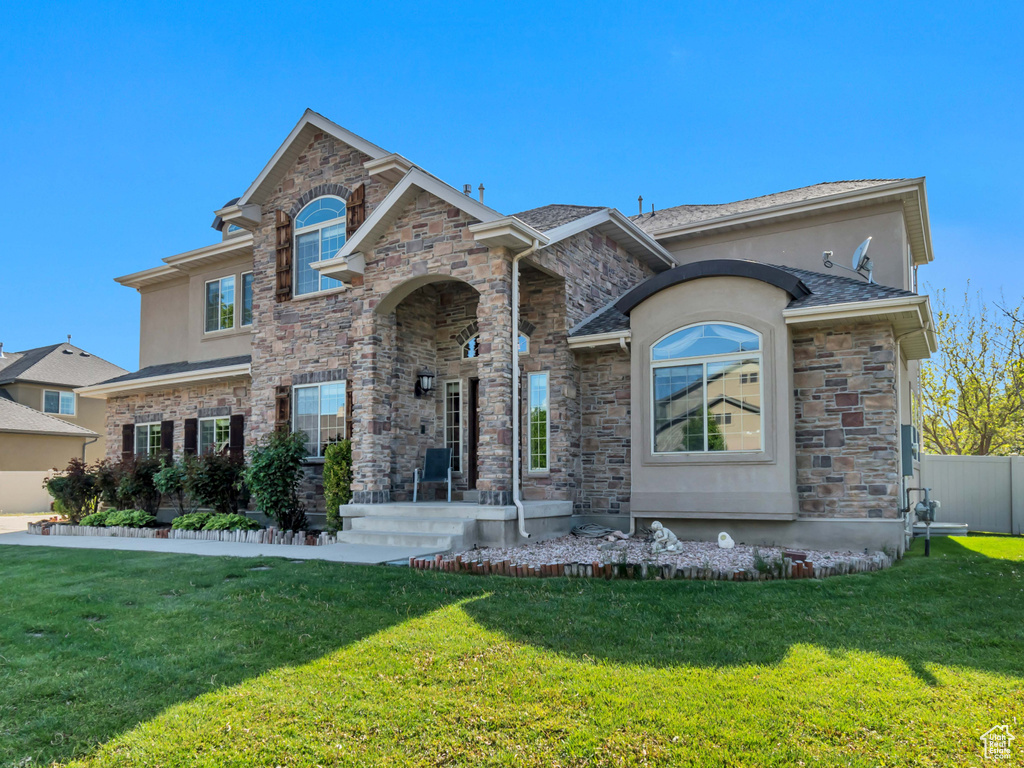 View of front of property with stone siding and stucco siding