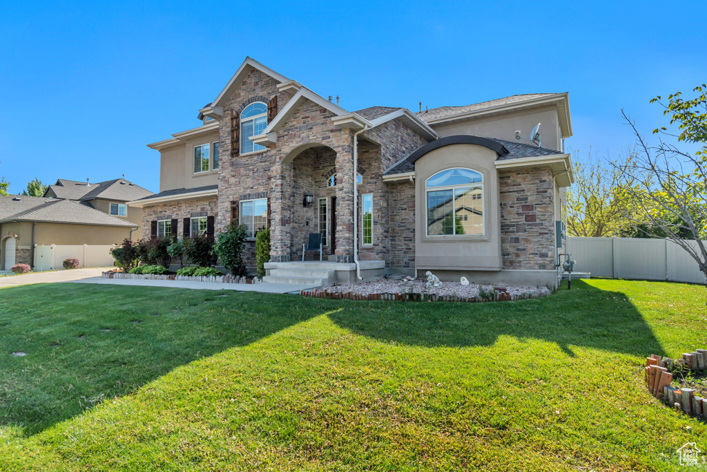 View of front of property with stone siding and stucco siding