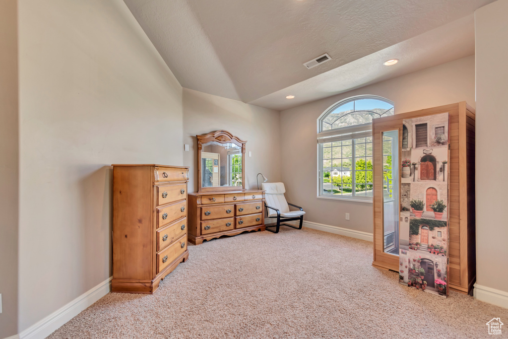 Living area featuring light carpet, baseboards, vaulted ceiling, and recessed lighting