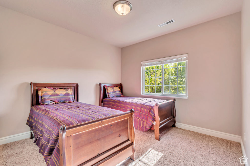 Carpeted bedroom featuring baseboards