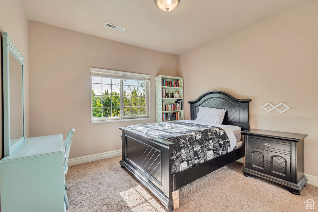Carpeted bedroom featuring baseboards