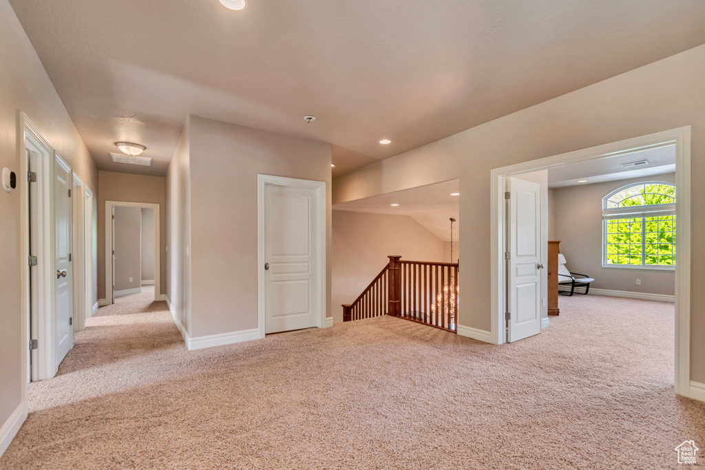Hall with an upstairs landing, carpet, baseboards, and recessed lighting