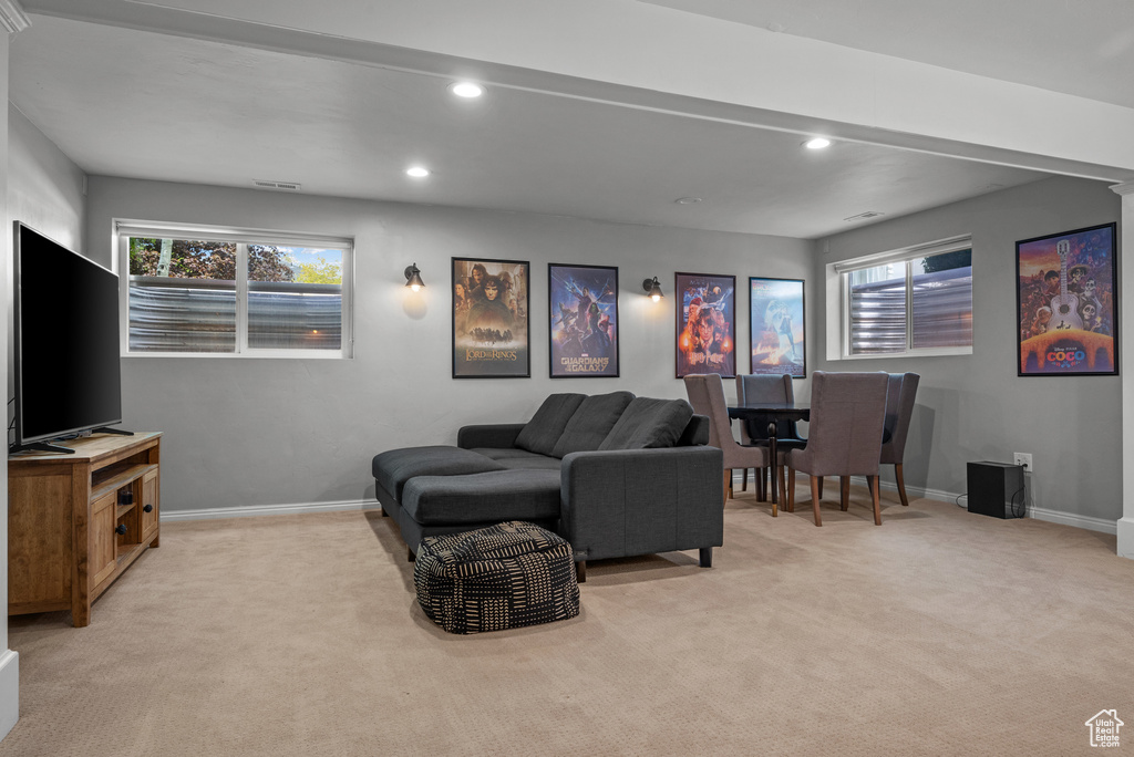 Living room with light carpet, baseboards, and recessed lighting