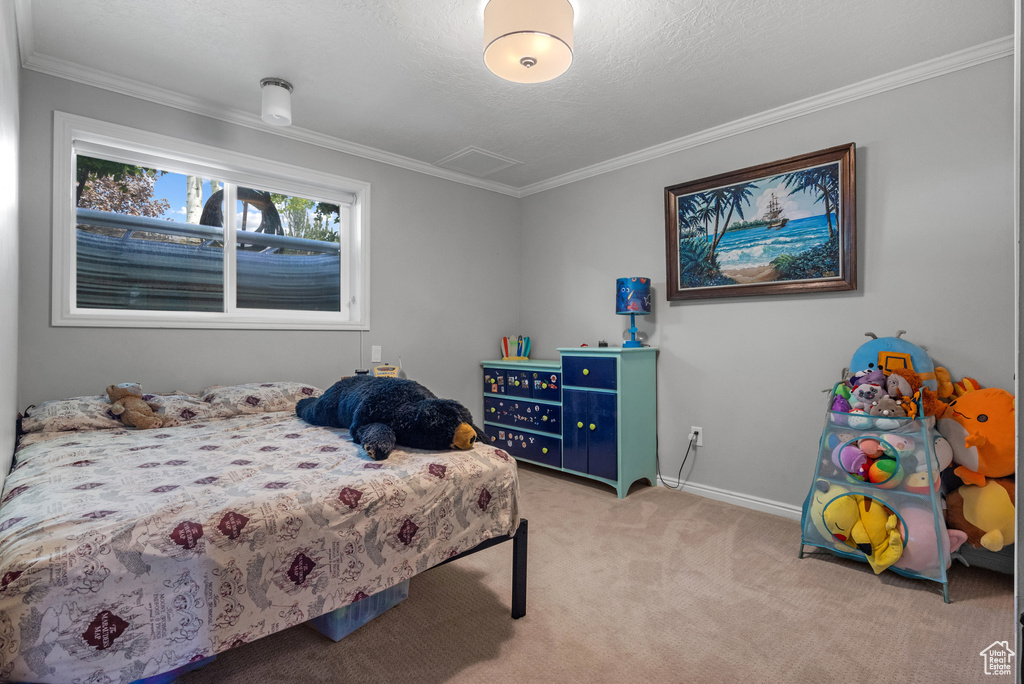 Carpeted bedroom with baseboards and ornamental molding