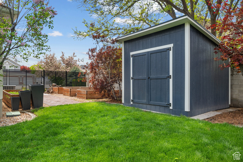 View of shed with a vegetable garden