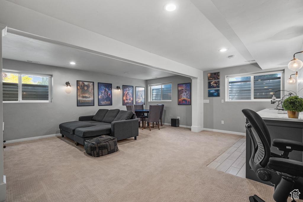 Home office with recessed lighting, baseboards, healthy amount of natural light, and light wood-style floors