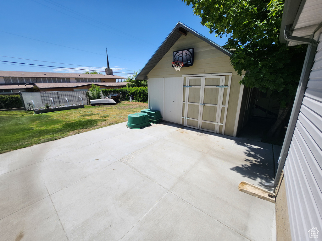 View of patio featuring an outdoor structure and a storage unit