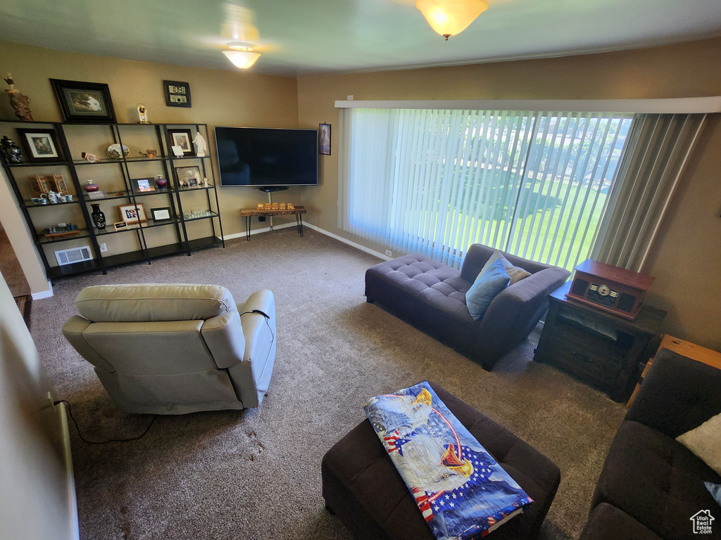 Living area featuring carpet flooring and baseboards