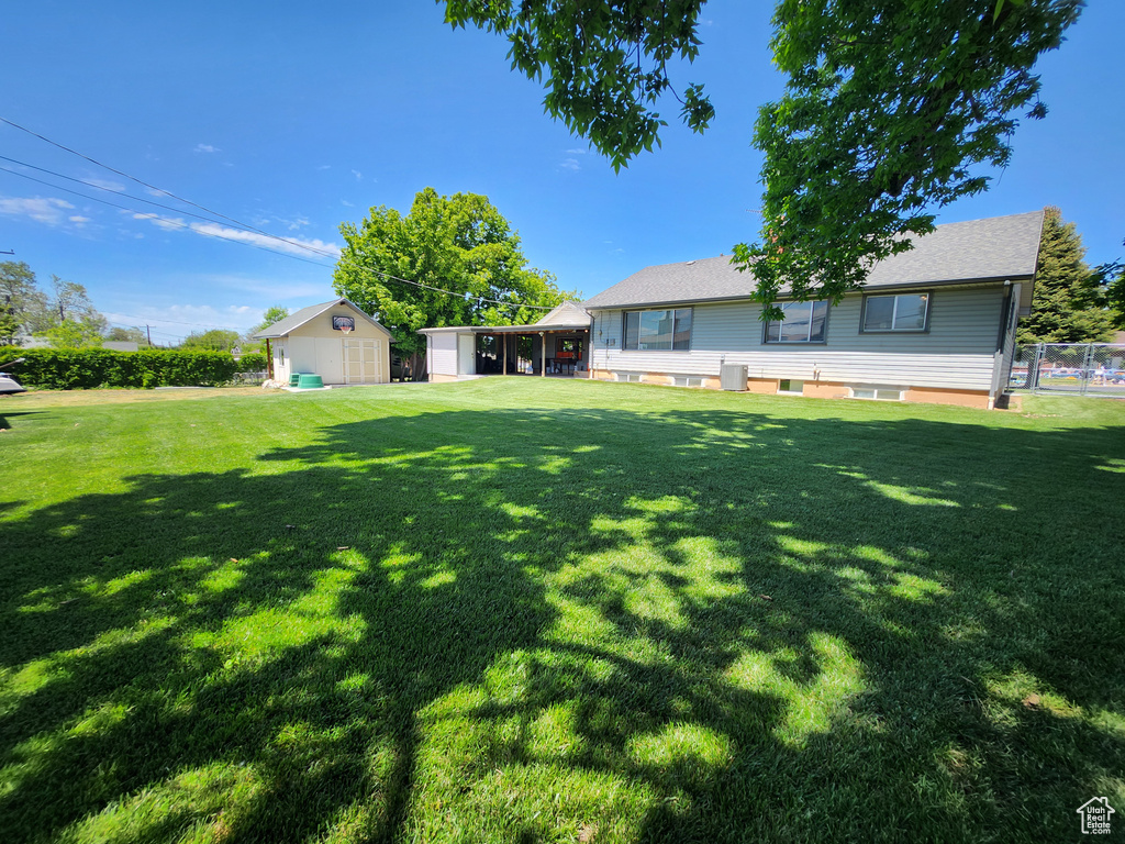View of yard with a storage shed and an outdoor structure