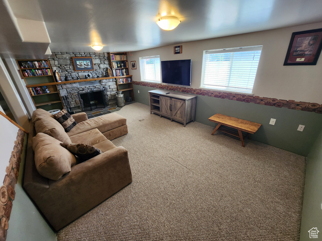 Carpeted living room with a fireplace