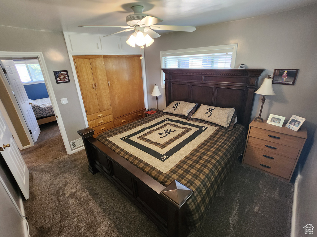 Bedroom featuring carpet flooring, a closet, attic access, a ceiling fan, and baseboards