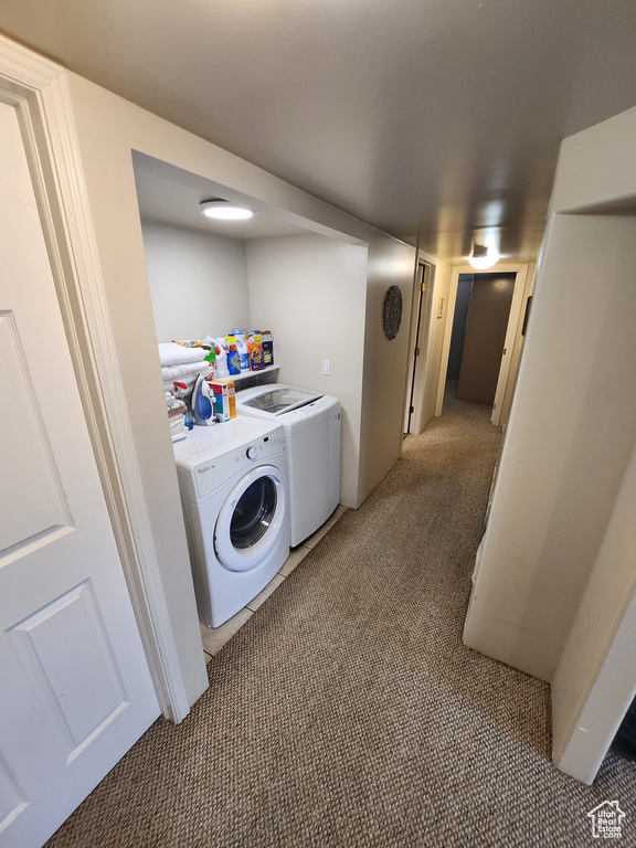 Washroom featuring washer and dryer and carpet floors