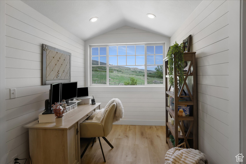 Office space featuring lofted ceiling, light wood-type flooring, wood walls, and recessed lighting