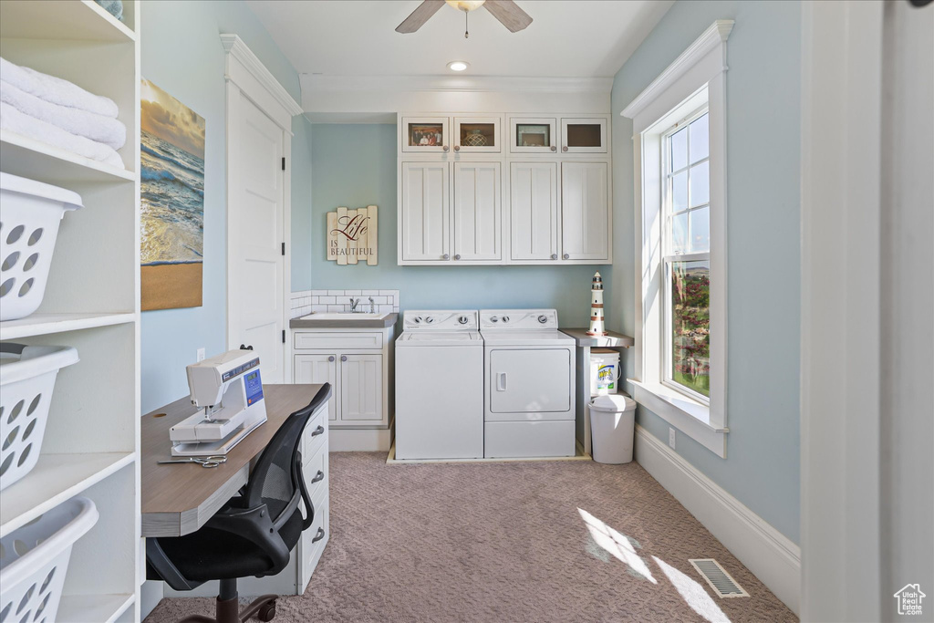 Washroom featuring separate washer and dryer, cabinet space, light colored carpet, ceiling fan, and an office area