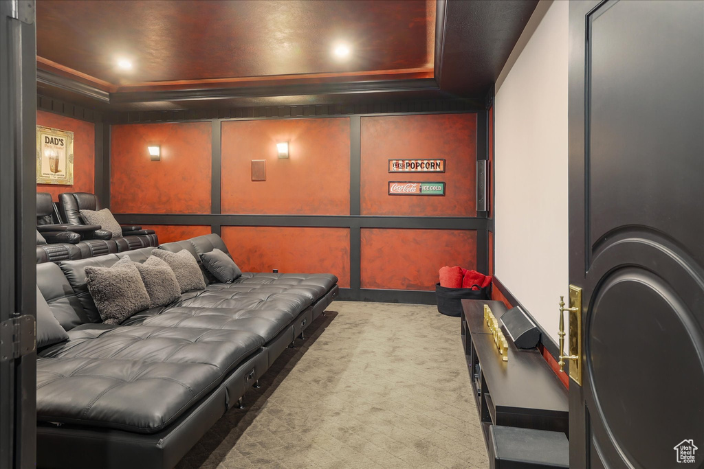 Home theater room featuring a raised ceiling, carpet floors, recessed lighting, and baseboards