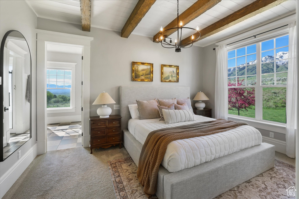 Bedroom with a chandelier, carpet floors, and beamed ceiling