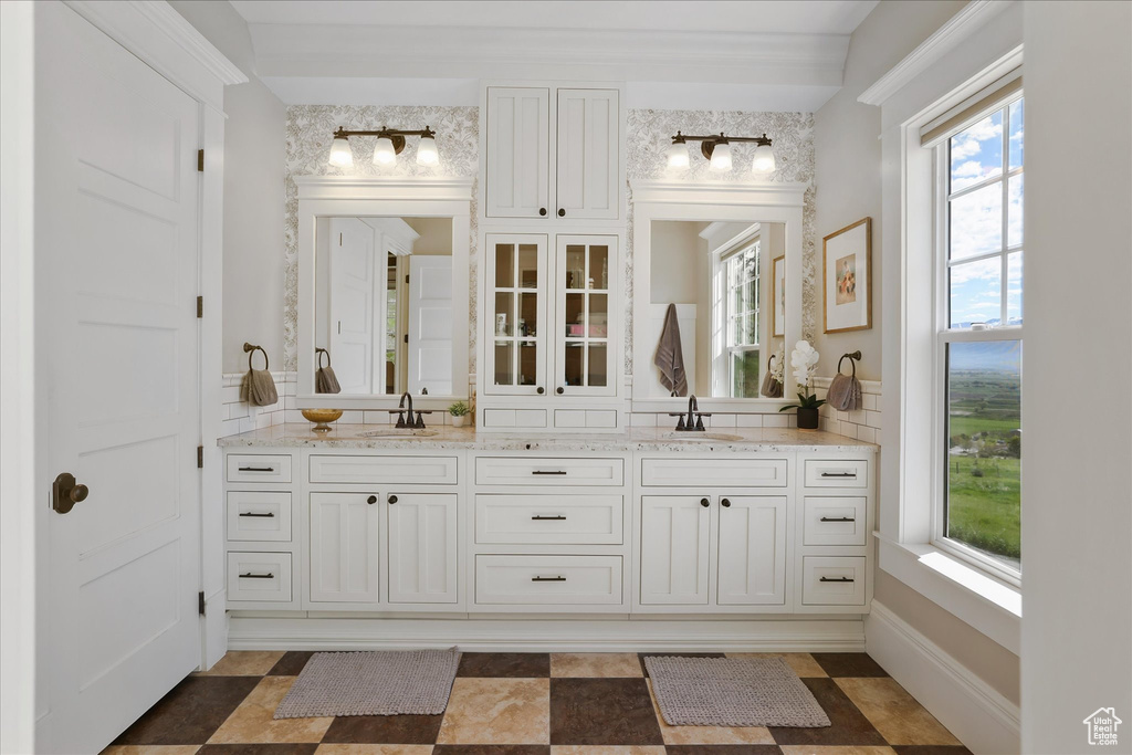 Full bathroom featuring plenty of natural light and double vanity