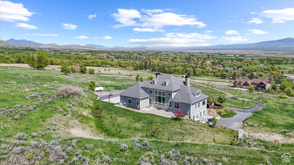 Aerial view of property and surrounding area with a mountainous background