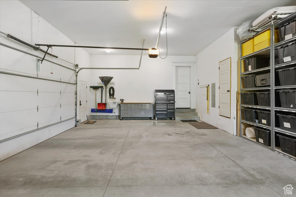 Garage with electric panel and a garage door opener