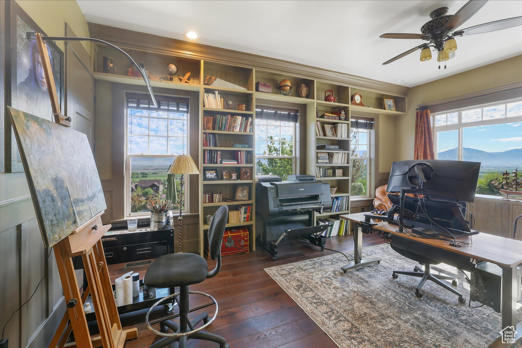 Office area with ceiling fan and dark wood finished floors