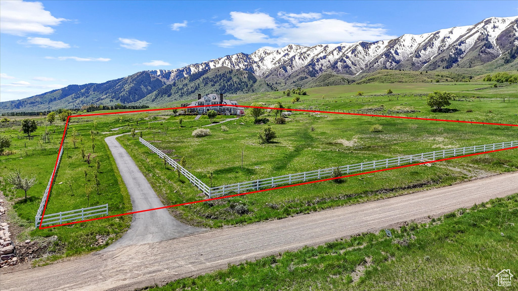 View of rural area featuring agricultural land, a mountain backdrop, and property parcel outlined