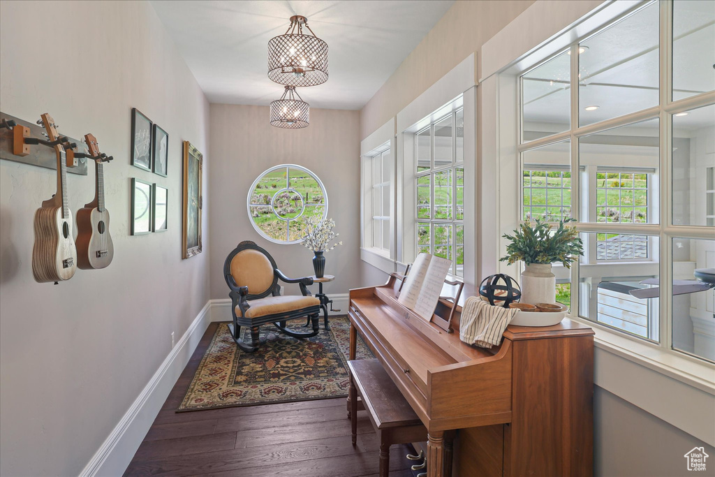 Office space with healthy amount of natural light, wood finished floors, and baseboards