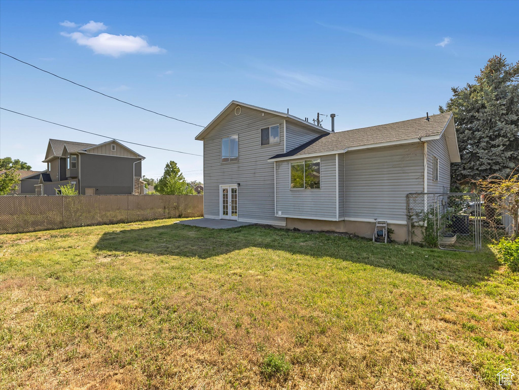 Back of house with french doors and a patio area