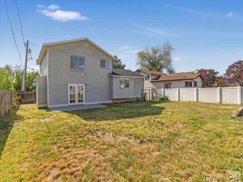 Rear view of property with french doors