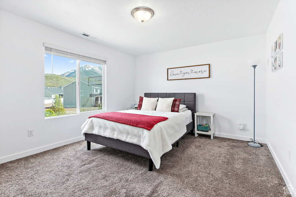 Carpeted bedroom with baseboards