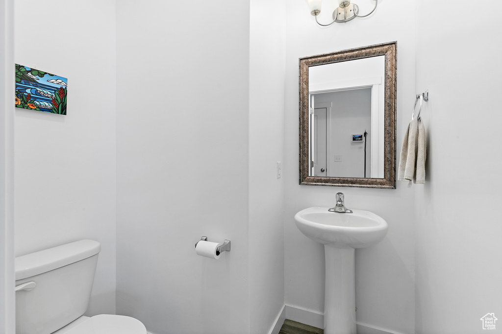Bathroom with toilet and baseboards