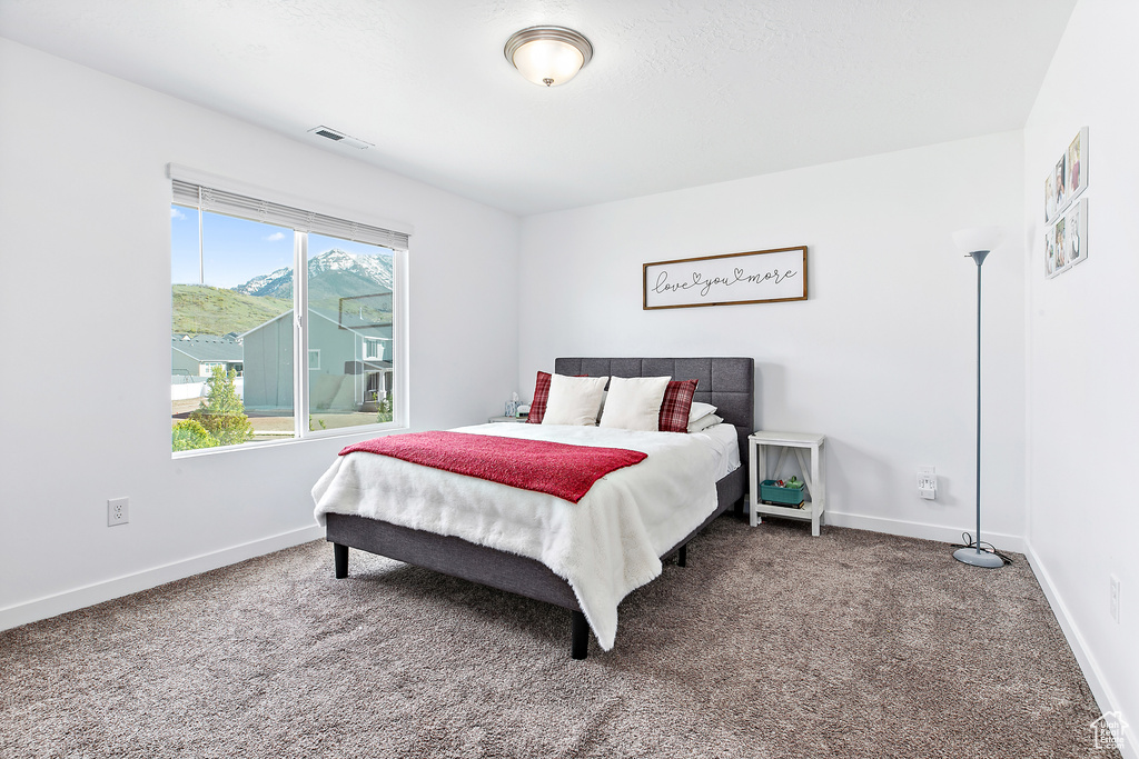 Carpeted bedroom featuring baseboards