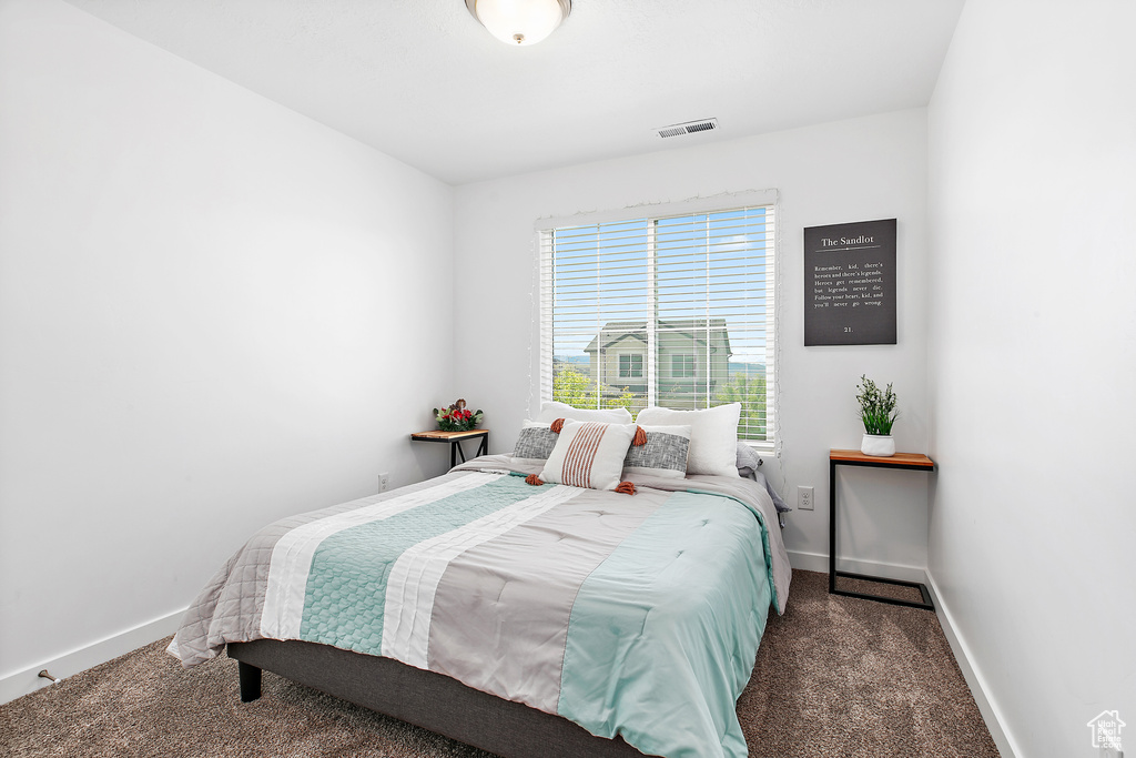 Bedroom with carpet floors and baseboards