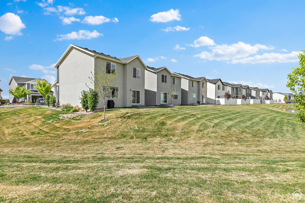 View of home's community with a residential view and a lawn