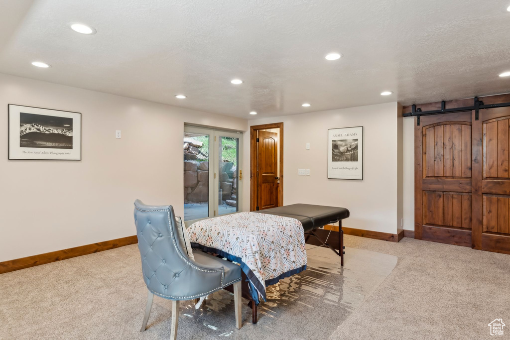 Dining area with baseboards, carpet flooring, recessed lighting, and a barn door