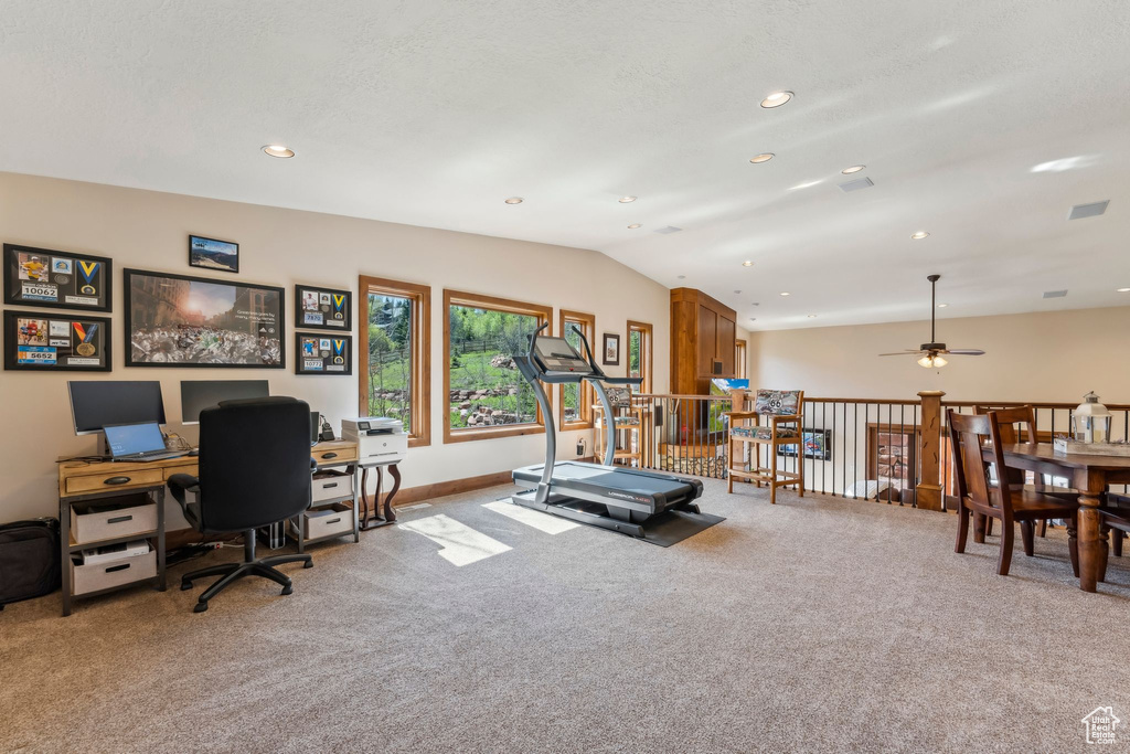 Exercise area featuring light colored carpet, a ceiling fan, lofted ceiling, recessed lighting, and baseboards